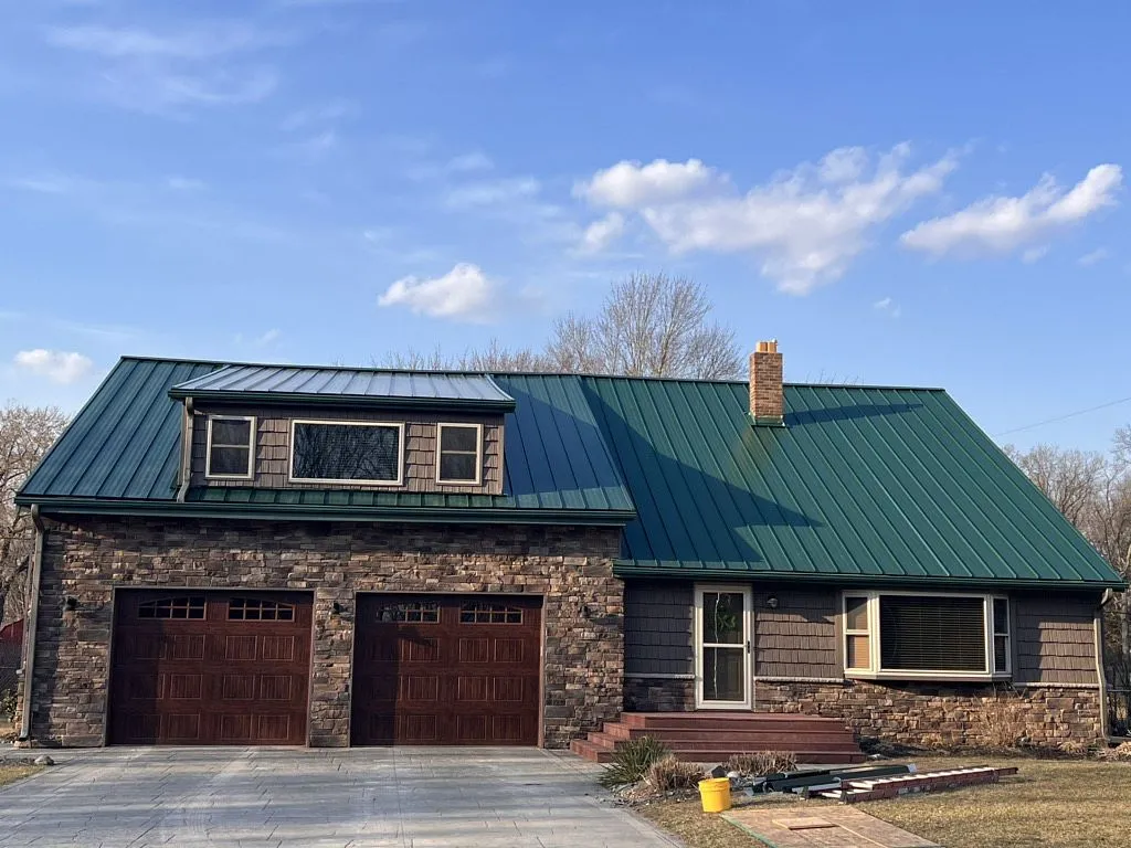 after replacement green standing seam metal roof with brick and chimney