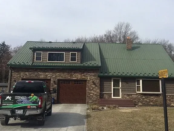 front view of old green metal roof before replacement