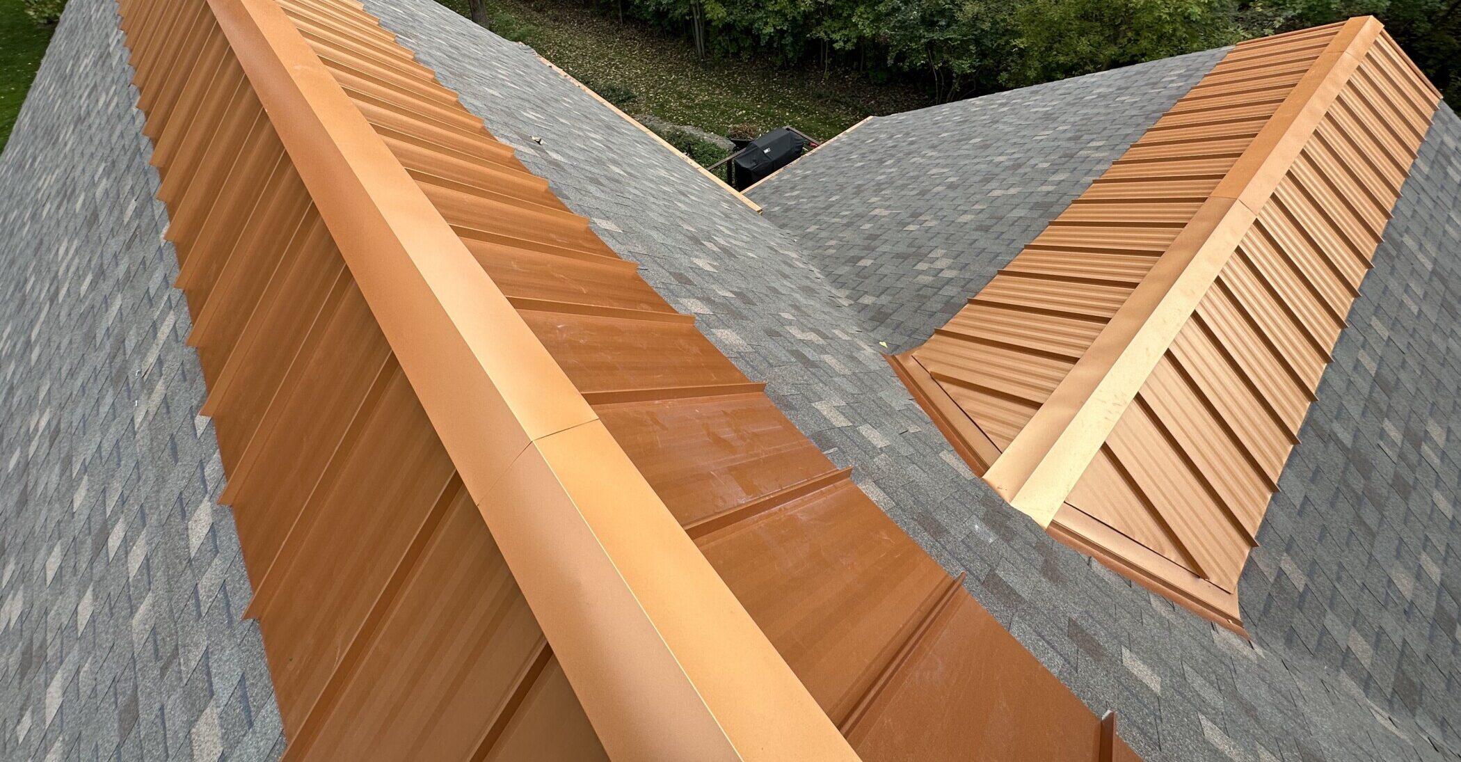 Copper metal ridge cap installed by Shingle and Metal Roofs