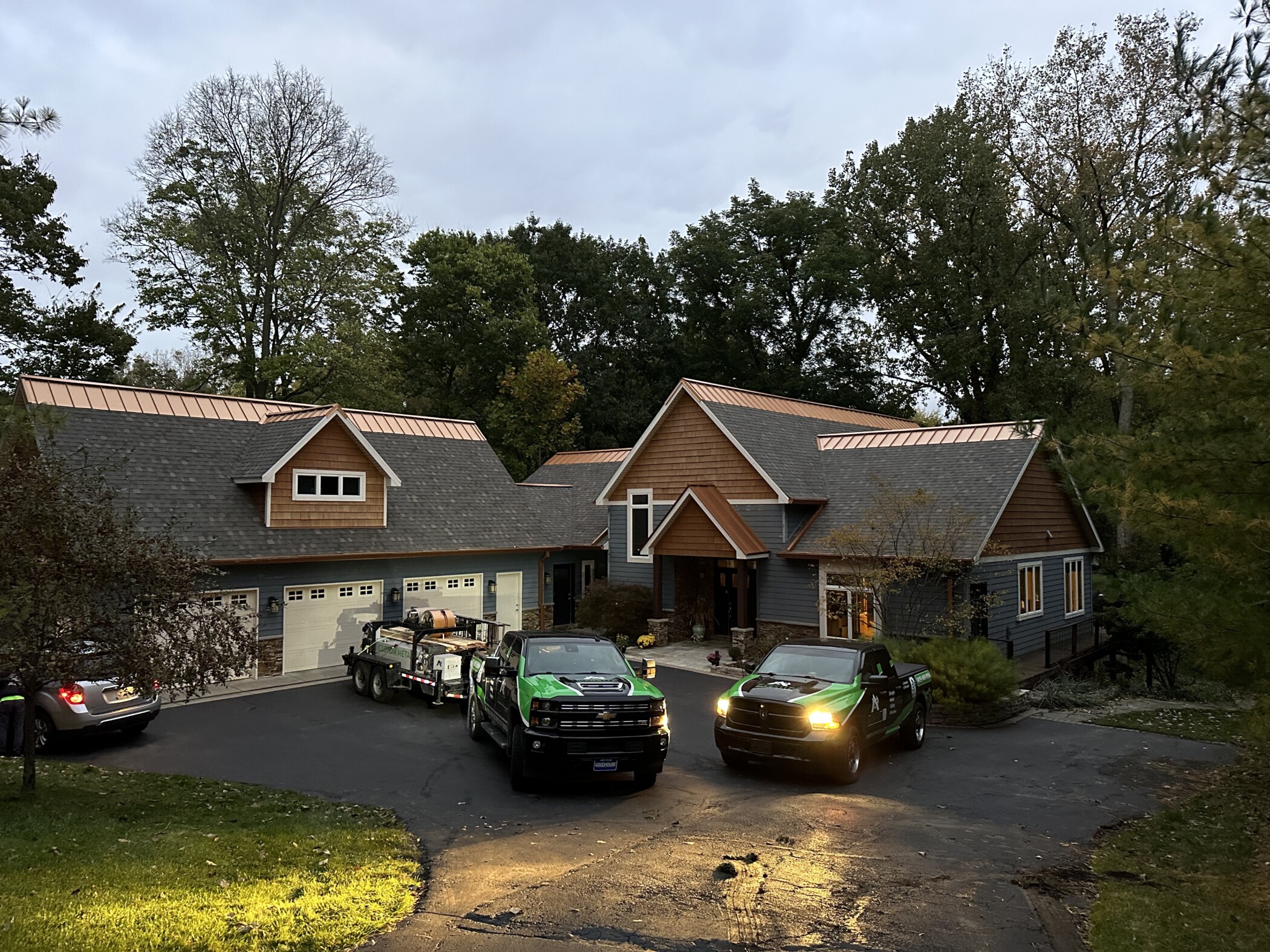 Shingle roofing installed with a copper metal ridge installed by Shingle and Metal Roofs in Michigan