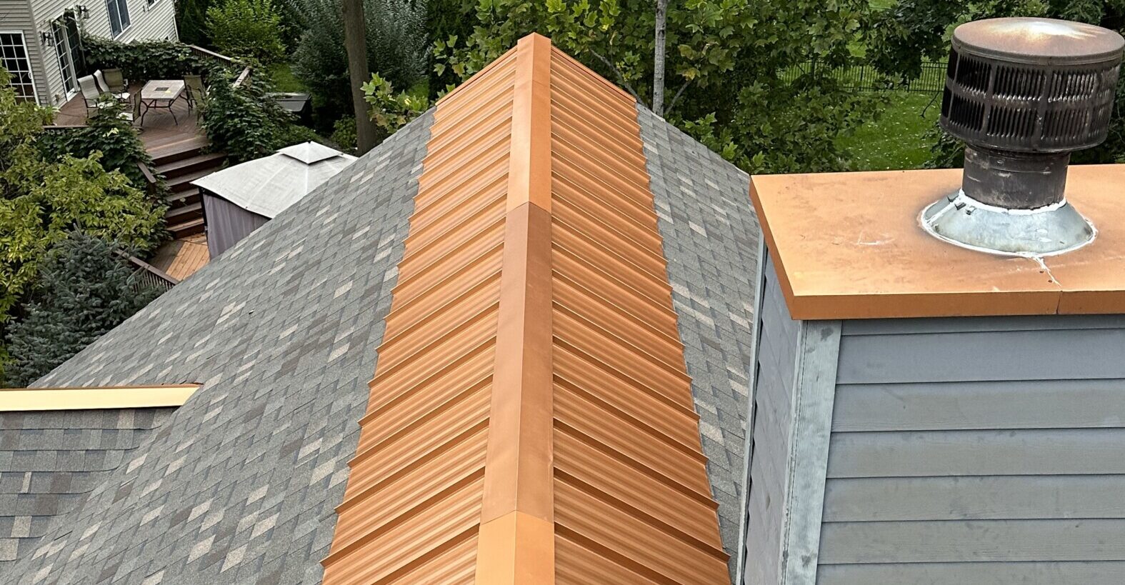 Copper ridge cap installed by Shingle and Metal Roofs