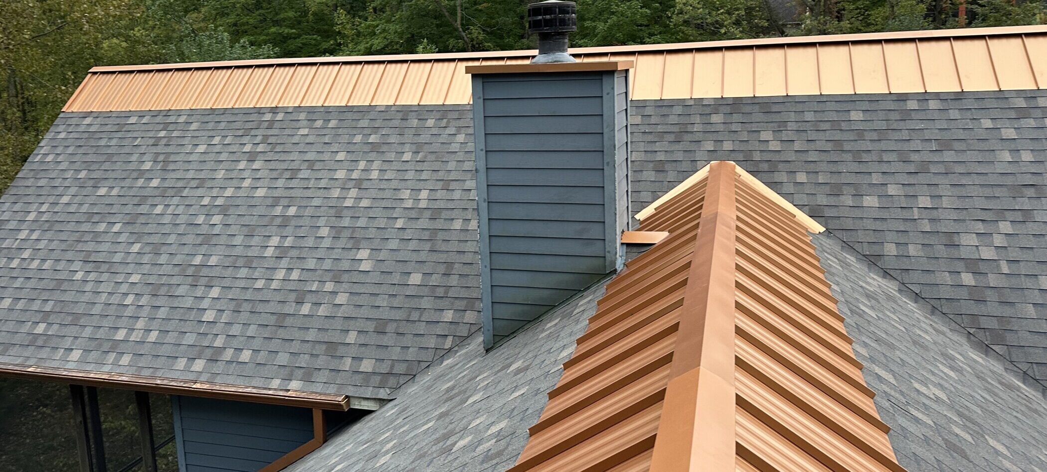 Shingle roof with copper metal ridge cap installed by Shingle and Metal Roofs