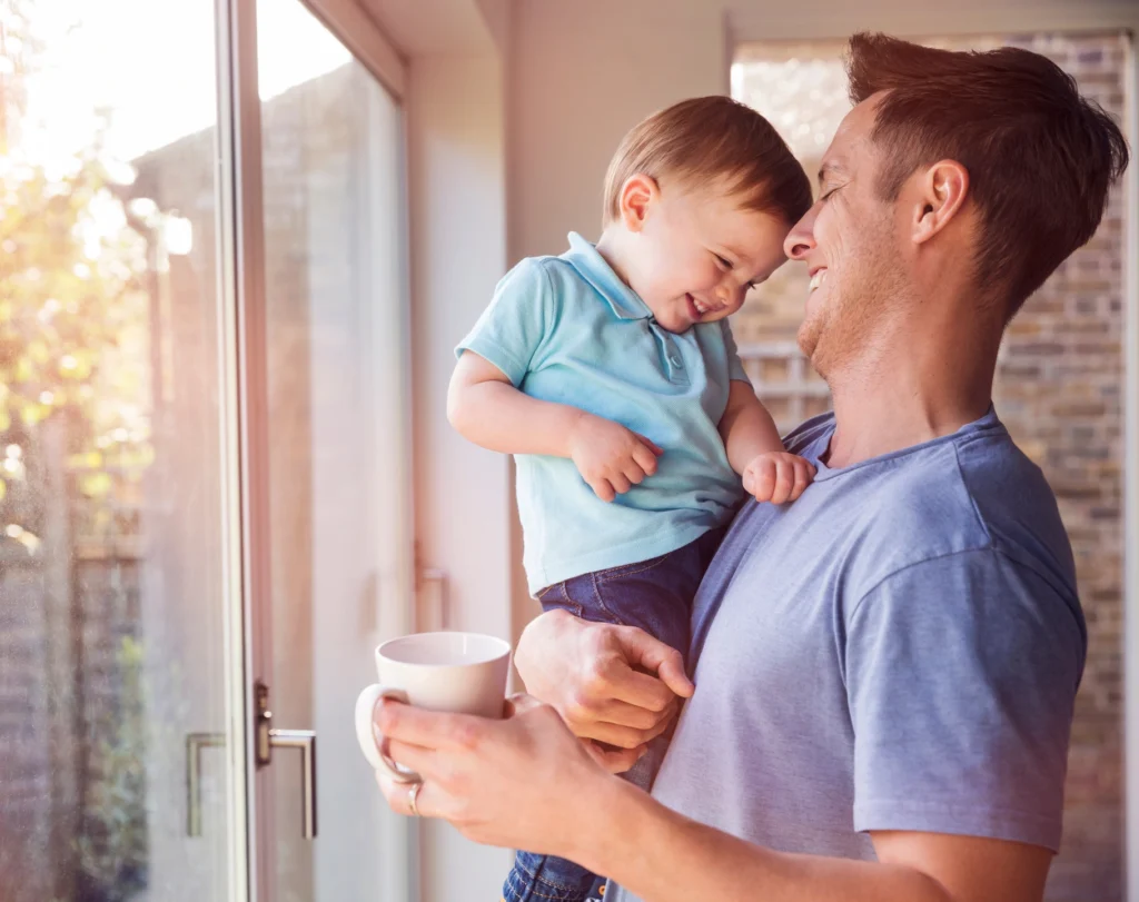 young father and son laughing at window after new replacement