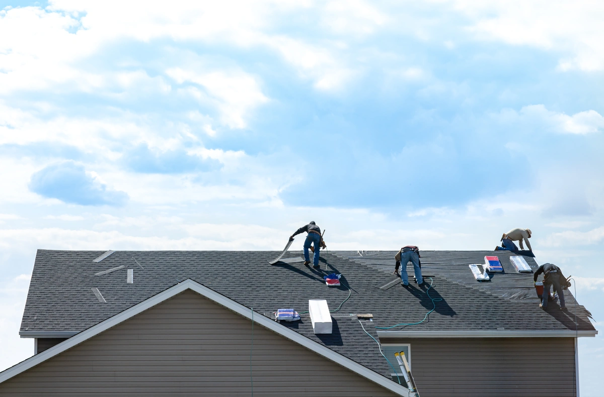 team of workers repairing the house roof