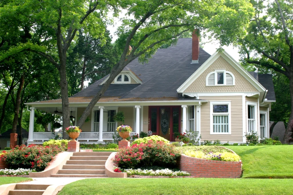 classic large family house with a flower garden and dark roof