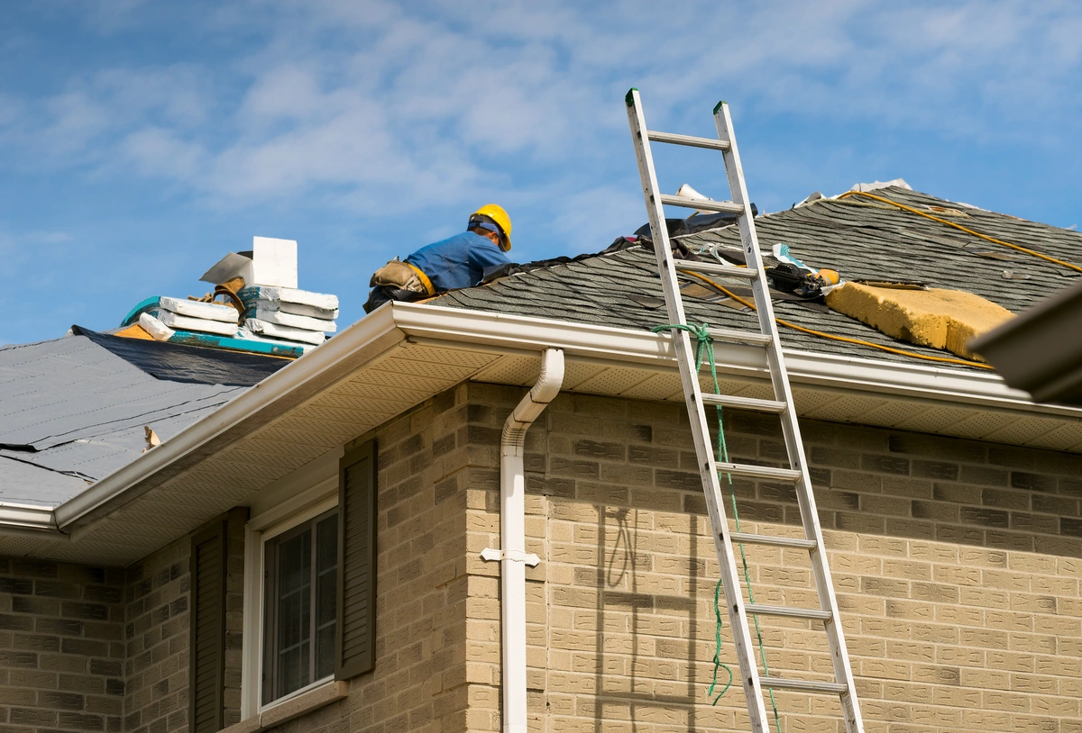 roofers repairing a roof leak on a home