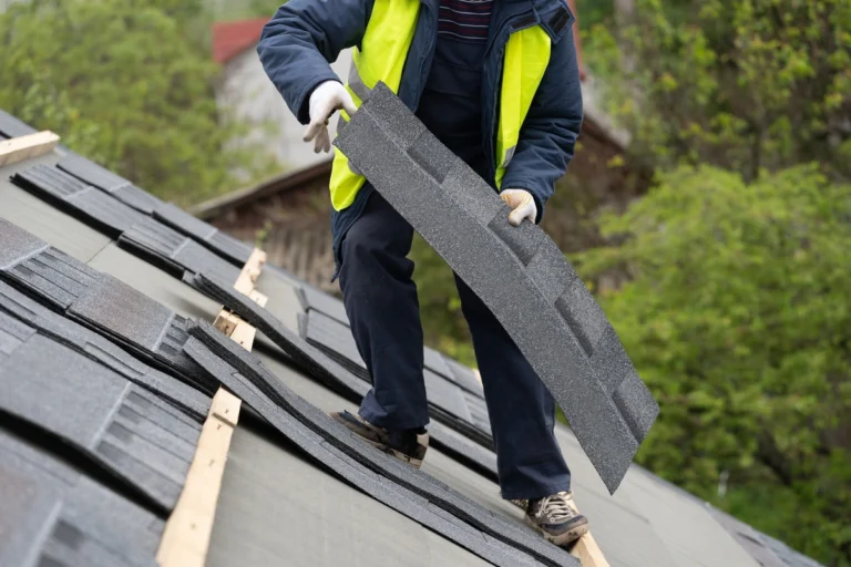 roofer preparing to install asphalt shingle on structure