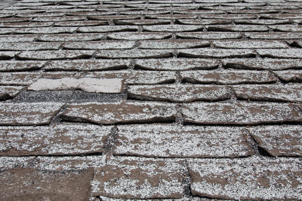 old and worn out asphalt roof shingles close up
