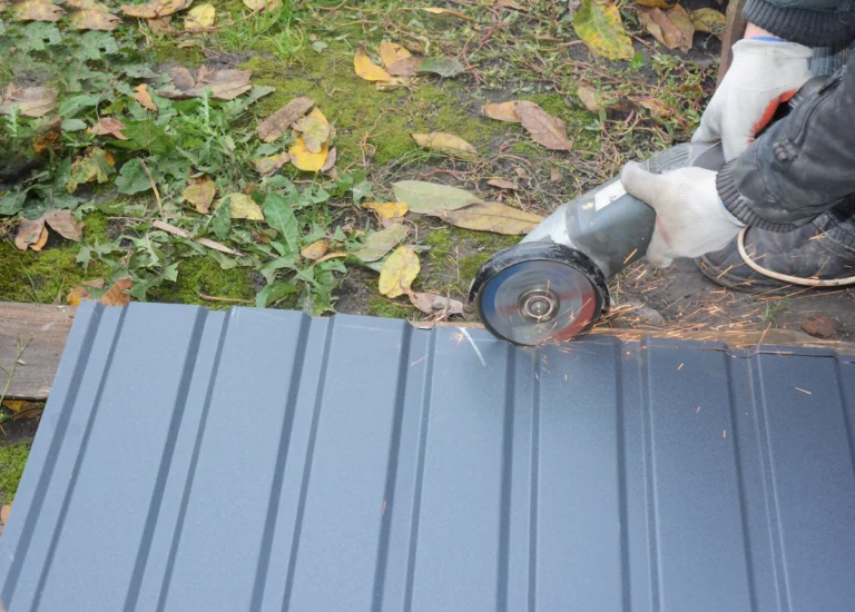 man cutting the metal roofing sheet