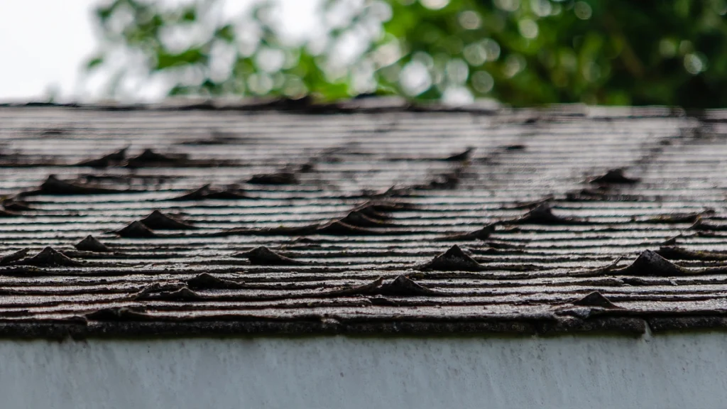 close up of curling shingles on a roof
