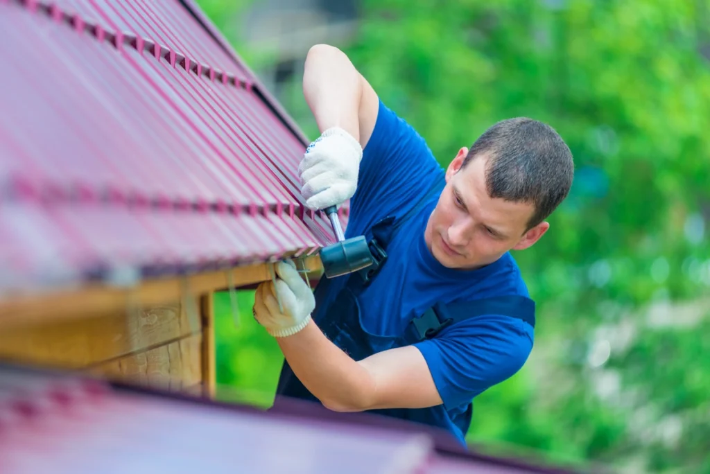A man is repairing the edge of his roof