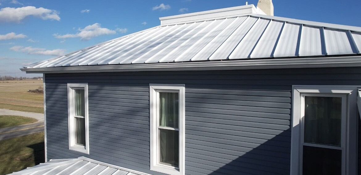 Home improvement work featuring Polar white standing steam metal, custom Polaris windows and blue Polaris vinyl siding installed by Shingle and Metal Roofs LLC