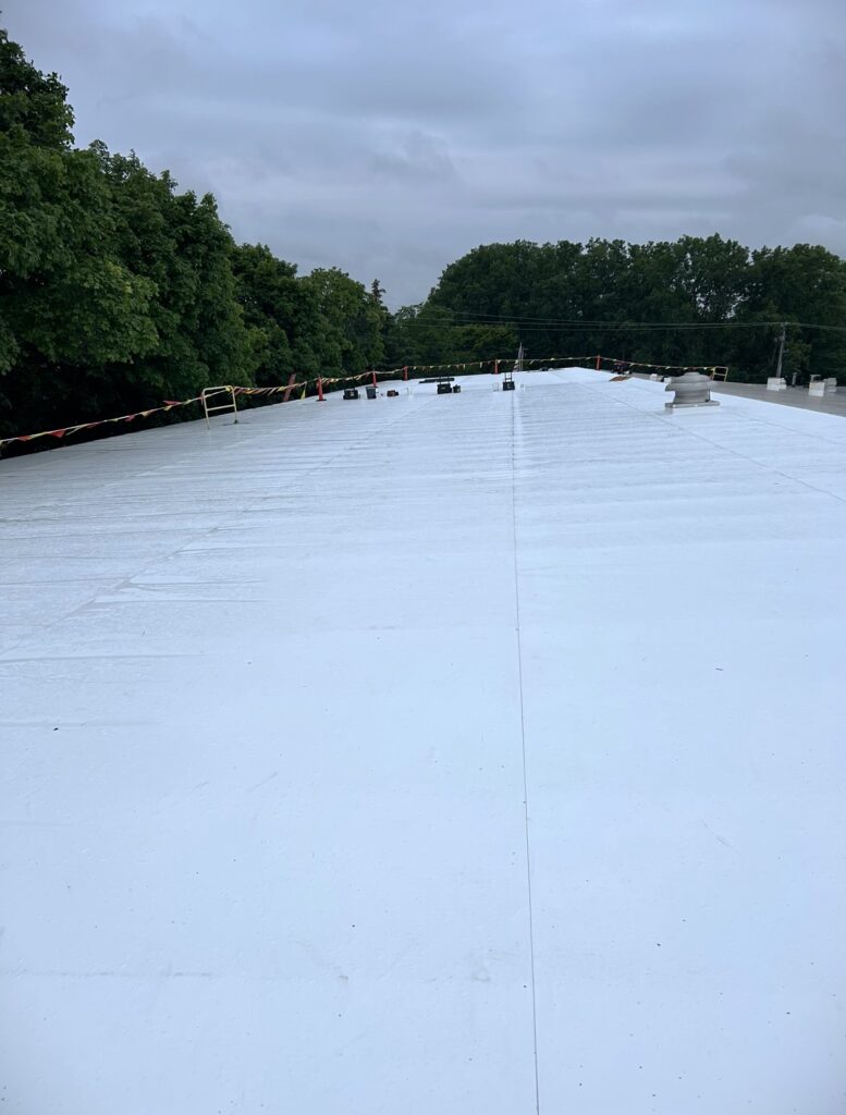 Roofers point of view on top of a recently replaced TPO commercial roof.